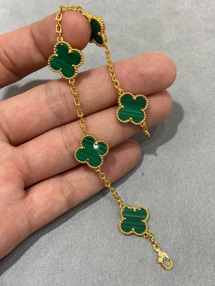 Gold bracelet with green clover-shaped charms 18kt gold plated from house of svarnaa