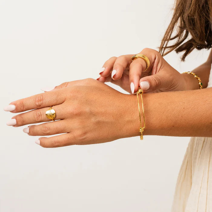Close-up of a person wearing 18kt Gold Plated jewelry house of Svarnaa on a plain background